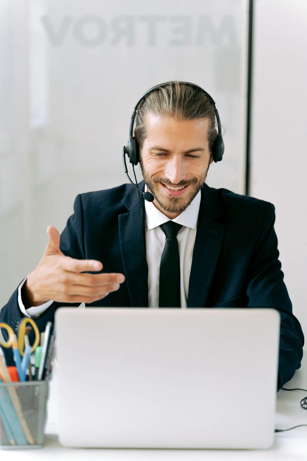 A Nomadoro legal advisor in a headset on a video consultation with a client.